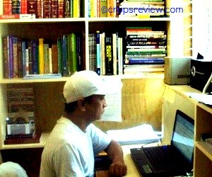 Ben Bareja immersed in creating a website cropsreview.com. Also shows a portion of his private library.